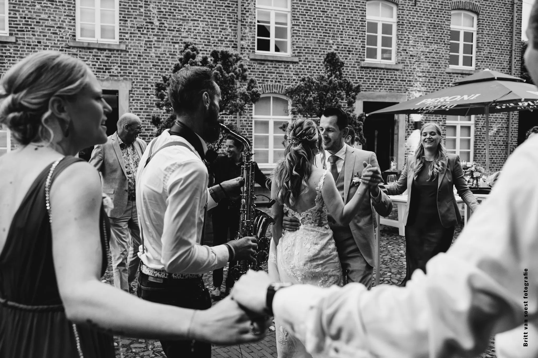 saxofonoonspel in een kring om het bruidspaar heen tijdens de trouwborrel Sax bij trouwborrel Sittard